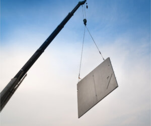 Slab of Concrete Hanging from Crane