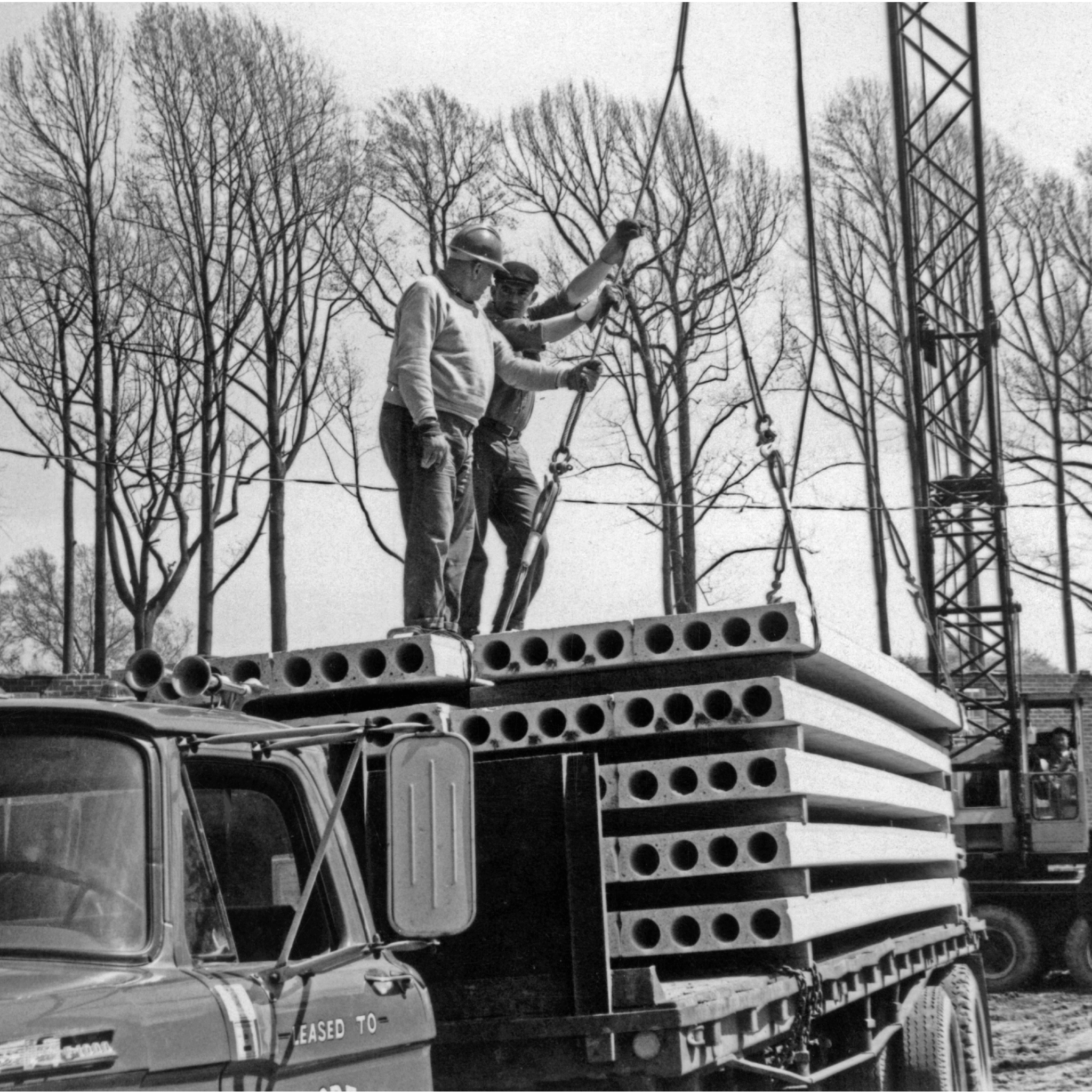 Two Workers on Truck Bed