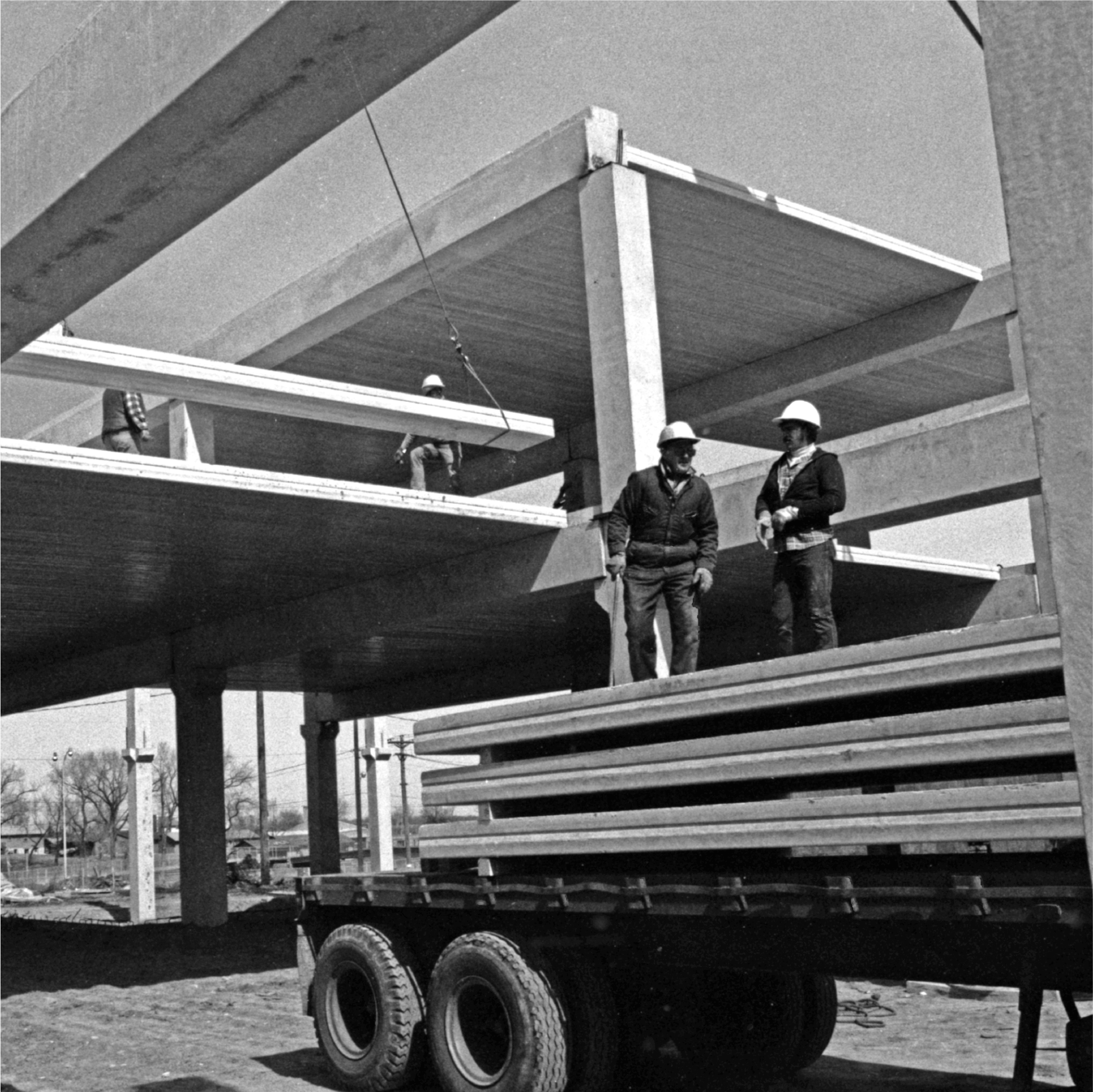 Workers on Truck Bed On Site